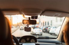 Woman looking in rear view mirror