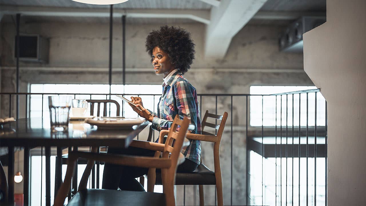 Woman online banking with a tablet