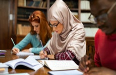 two young persons studying at a library