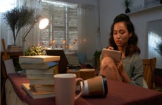 College student studies in dorm room.