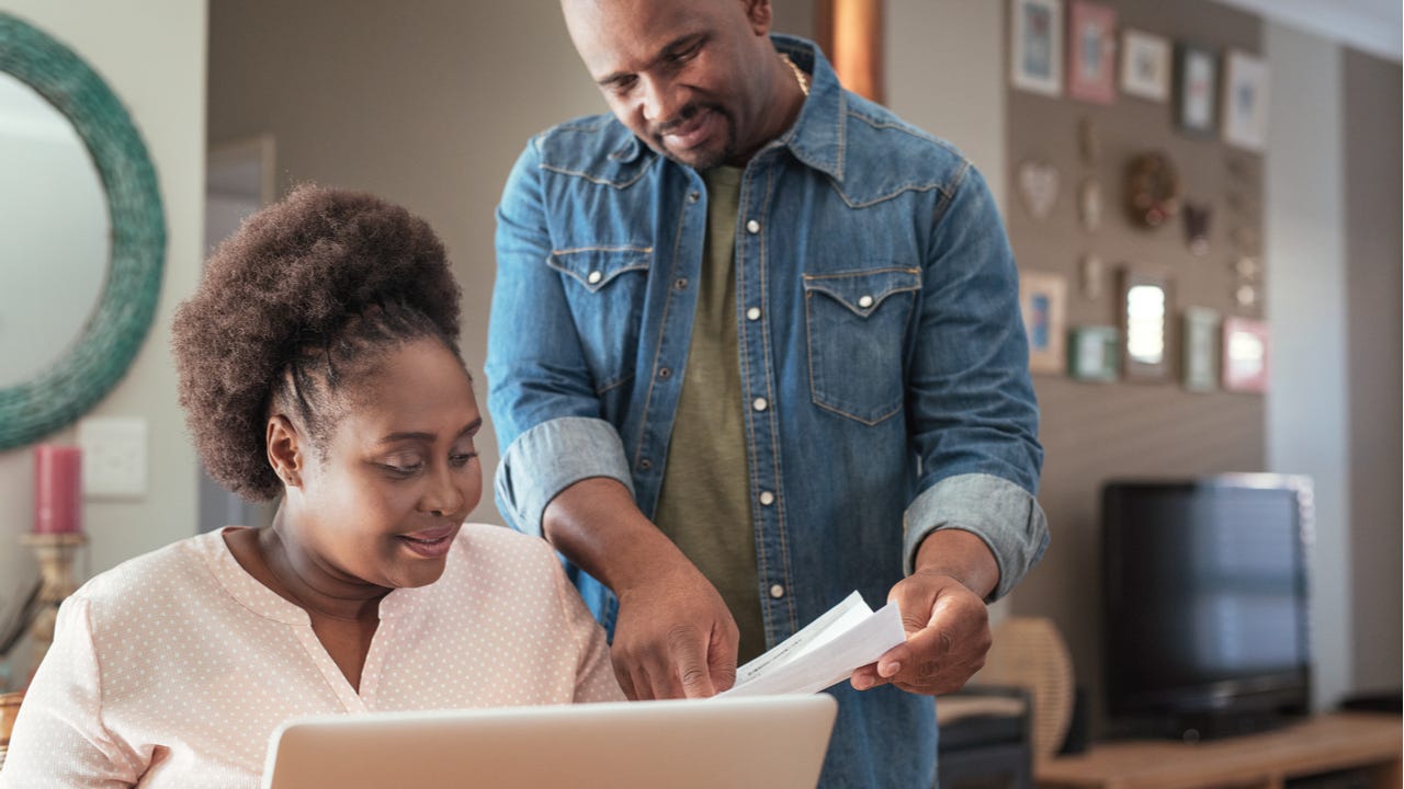 Middle-aged couple looking at paperwork together