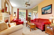 An interior living room with seating area, coffee table and fireplace