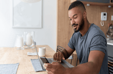 Man working on laptop and phone