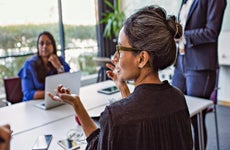 business woman talking to colleagues in a meeting