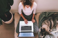 A woman works on her laptop.