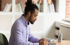 man works at a laptop at a desk