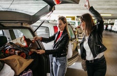 friends putting luggage in a car