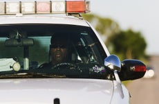 Police officer sitting in a police car