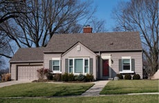 A one-story single-family home with attached garage and front yard walkway