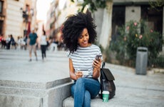 Young woman on phone with credit card