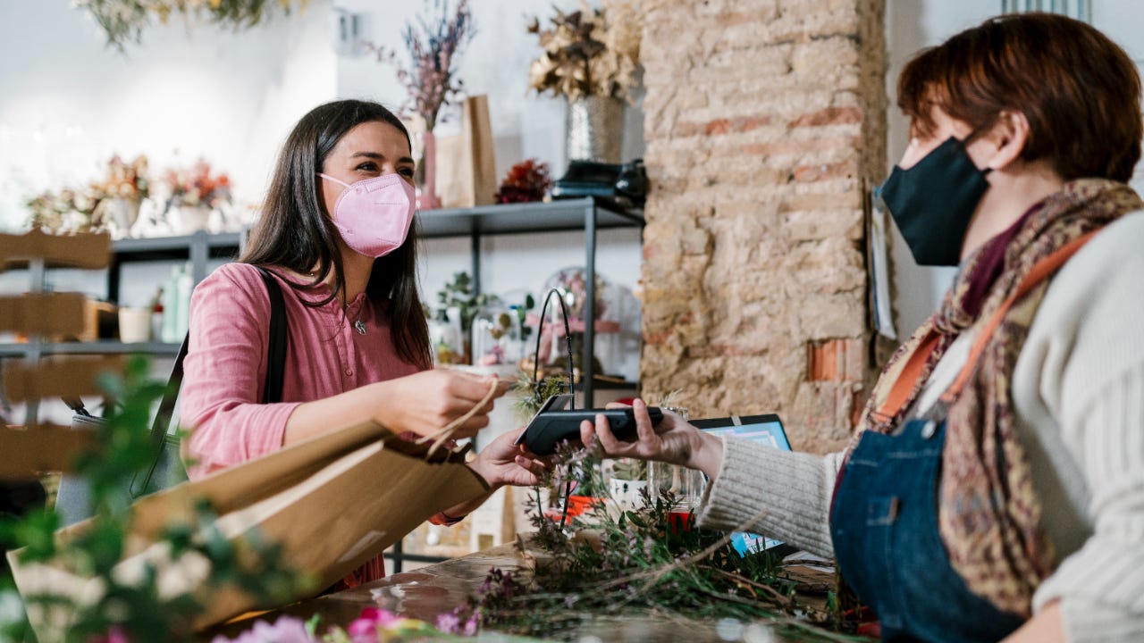 Woman making purchase at plant nursery