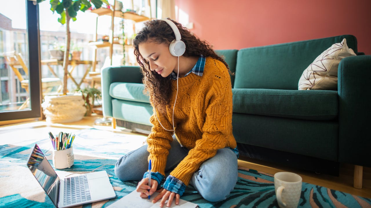 Student using laptop in a living room