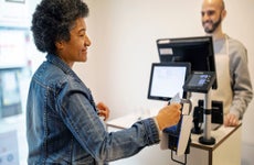 woman using tap to pay at a store