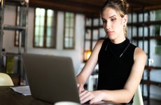 young woman working on laptop at home