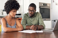 couple looking through paperwork at home