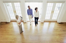 Real estate agent walking into a home with a couple