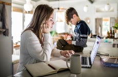 Mom researching on laptop in kitchen