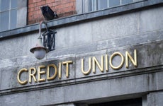 Credit sign on stone wall building