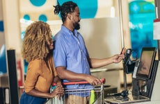 couple checking out at supermarket