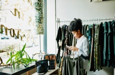 Woman checking smartphone while shopping