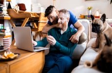 Close up of a male couple online shopping on their laptop