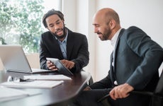 appraisal waiver - loan officer explaining data on computer and tablet to a client