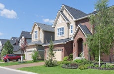 Several brand new suburban houses in sunny summer afternoon