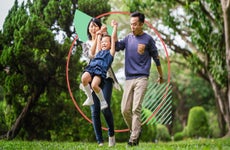 Family with child enjoying a nice time in the park on a clear day