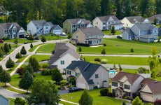 suburban neighborhood with trees and green grass