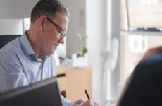 Male colleagues in discussion at office desk