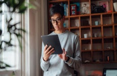 man banking online with digital tablet at home