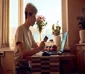 woman working on laptop at home while holding credit card