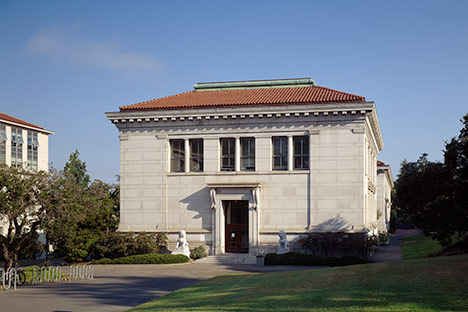 Stone building with red tile and copper roof.