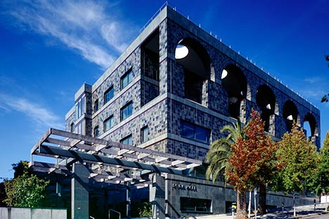 Multi green color tile building with trees and blue sky