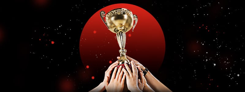 netball trophy with players' hands holding it