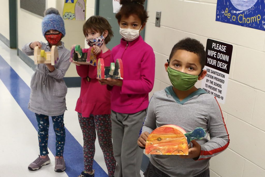 Children showing their artwork