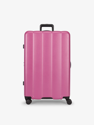 CALPAK raspberry large luggage made from an ultra-durable polycarbonate shell and expandable by up to 2