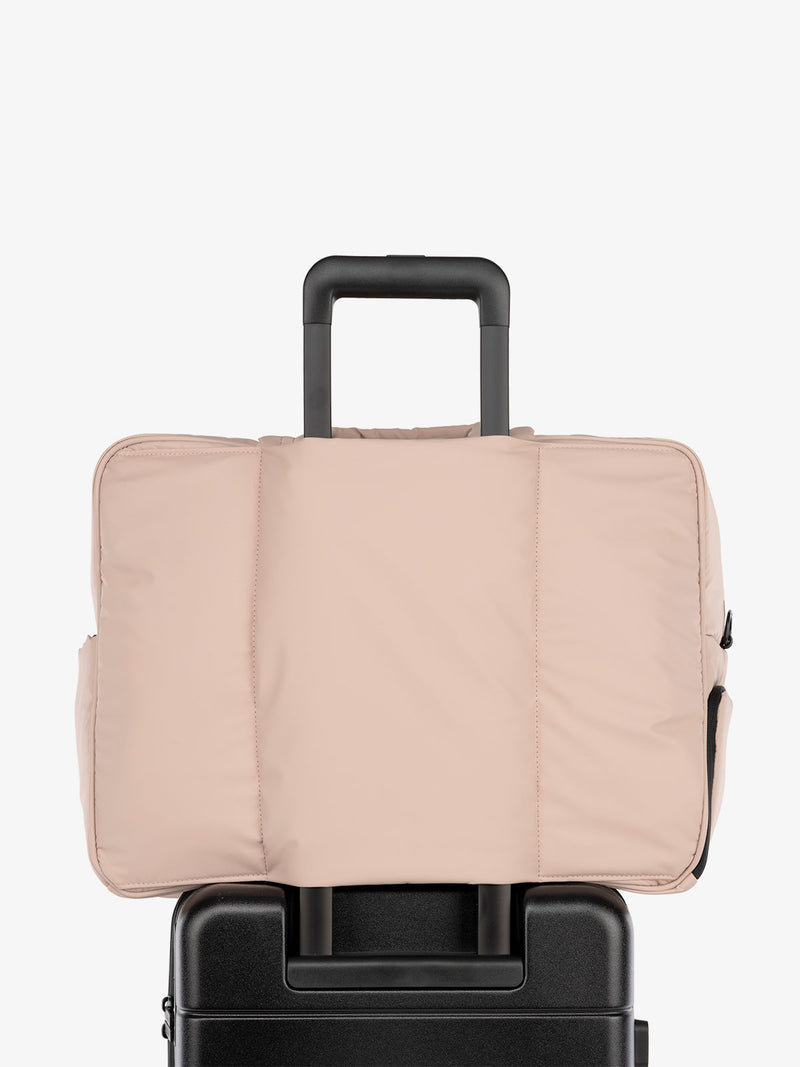 CALPAK Luka large travel duffel bag with trolley sleeve for luggage in light pink