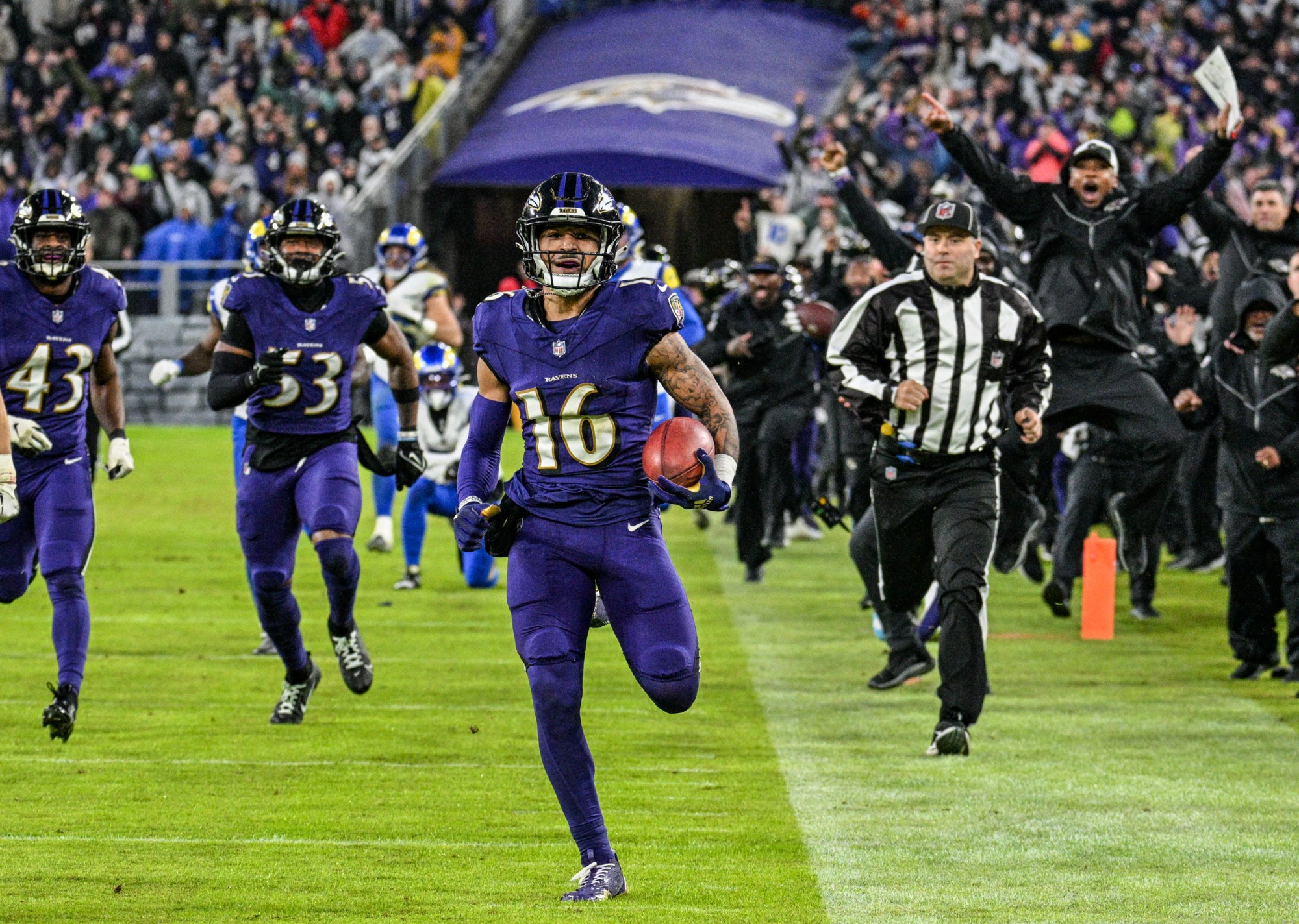 Baltimore Ravens Tylan Wallace runs toward the end zone, retuning a punt for a touchdown as the Baltimore Ravens defeat the Los Angeles Rams 37-31 in overtime at M&T Bank Stadium. (Jerry Jackson/Staff photo)