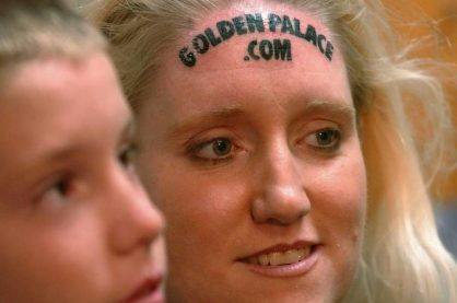 Women's GoldenPalace.com forehead tattoo