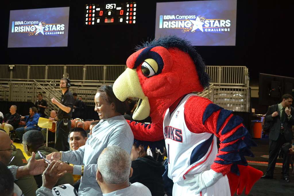 A U.S. Army soldier takes a selfie with Atlanta mascot Harry the Hawk