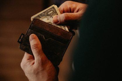 Person getting money out of wallet