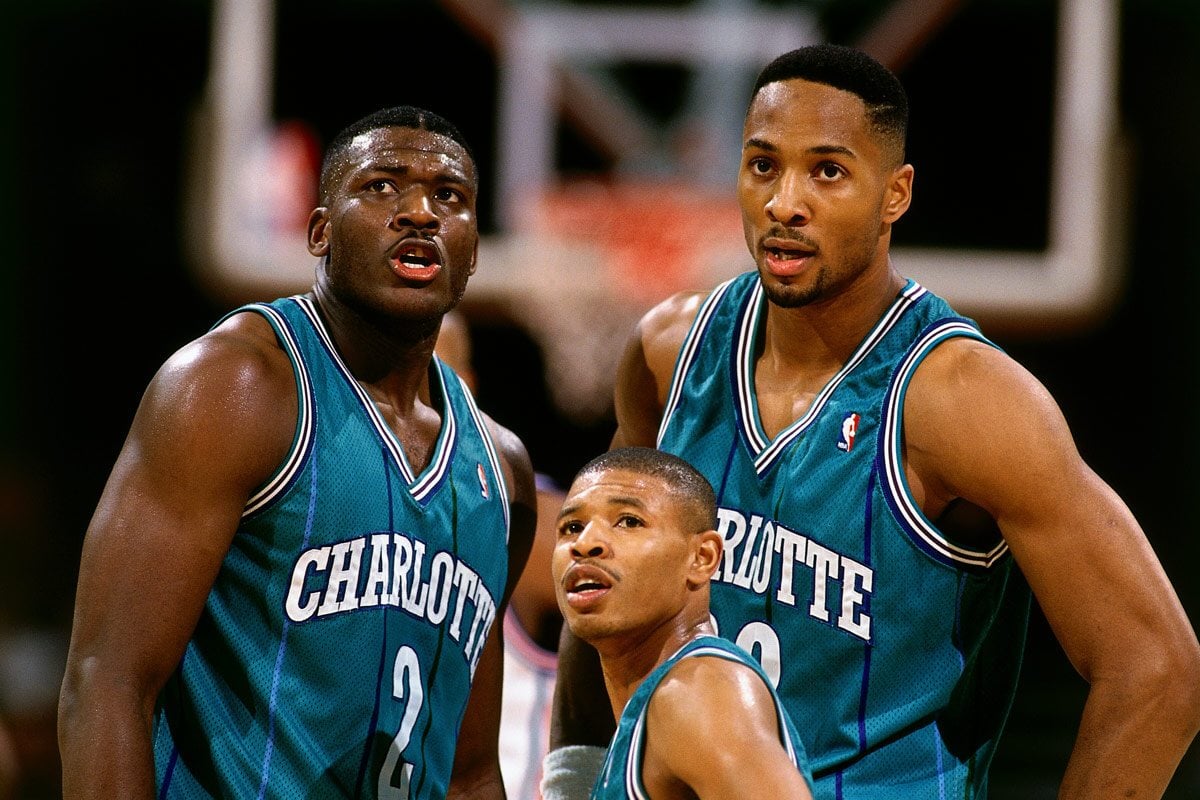 The shortest ever NBA player Muggsy Bogues with Larry Johnson and Alonzo Mourning