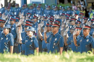 Philippine PNP police officers participate in a swearing-in ceremony