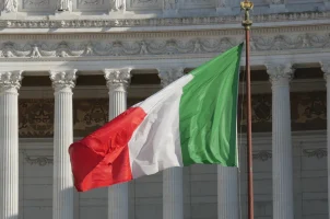 The Italian flag in front of the Victor Emmanuel II National Monument in Rome