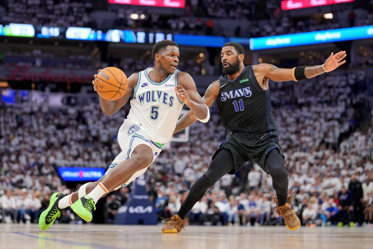Minnesota Timberwolves guard Anthony Edwards (5) controls the ball against Dallas Mavericks guard Kyrie Irving (11) in the second quarter during game two of the western conference finals for the 2024 NBA playoffs at Target Center.