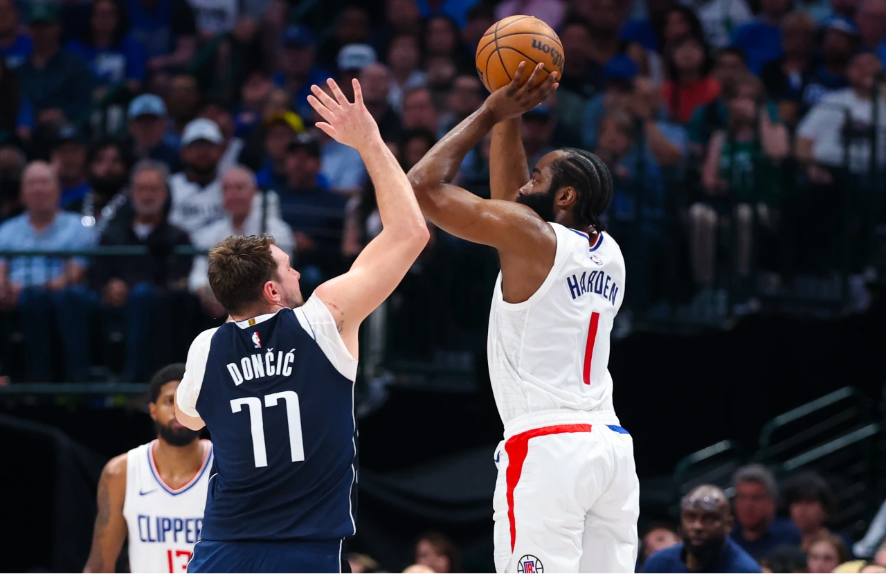 LA Clippers guard James Harden (1) shoots over Dallas Mavericks guard Luka Doncic (77) during the first half during game four of the first round for the 2024 NBA playoffs at American Airlines Center.