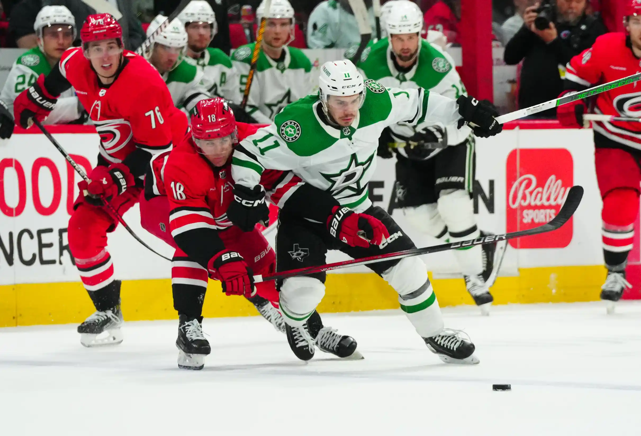 Dallas Stars center Logan Stankoven (11) battles for the puck against Carolina Hurricanes center Jack Drury (18) during his first NHL game during the second period at PNC Arena.