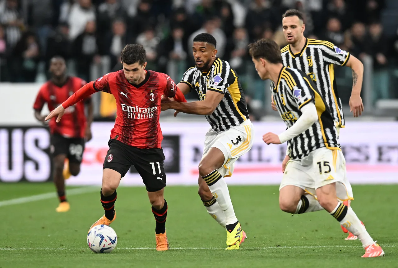 AC Milan player Christian Pulisic in action with Juventus player Bremer at Allianz Stadium.