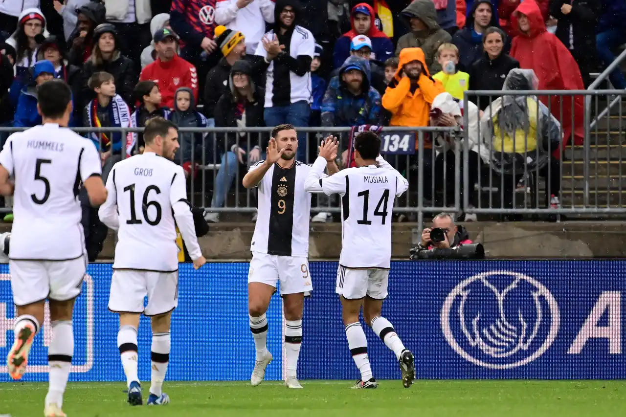 Germany midfielder Jamal Musiala (14) celebrates with forward Niclas Fullkrug (9) after scoring a goal against the United States men's national team during the second half at Pratt & Whitney Stadium.